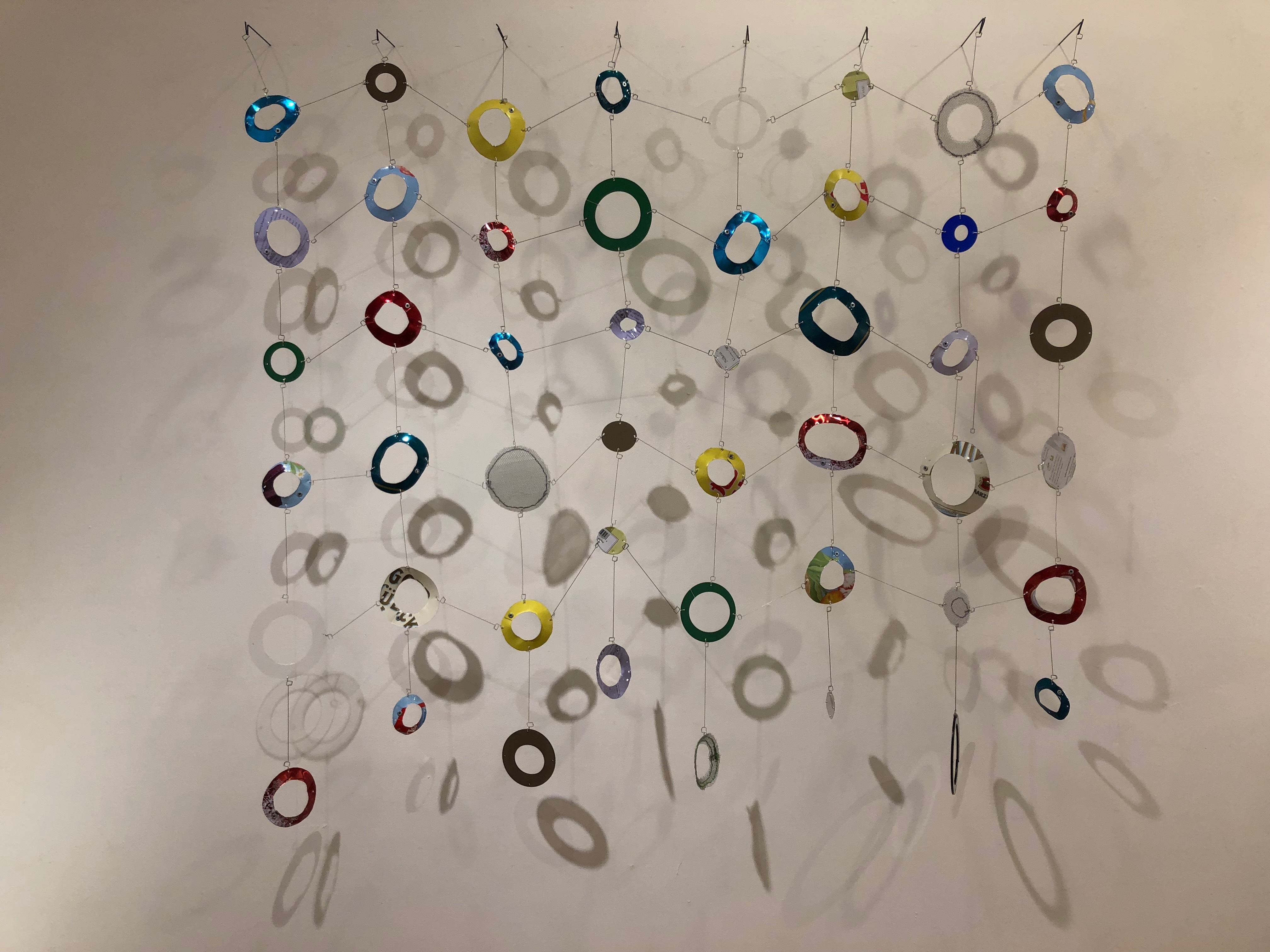 Circle Practice and Chevrons, 41 x 43 x 5". wire, rubber, leather, found objects